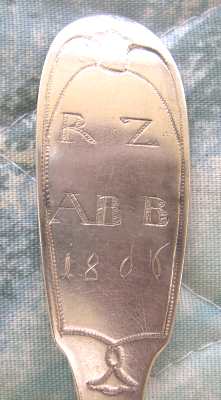 spoon showing two sets of initials and the year 1806