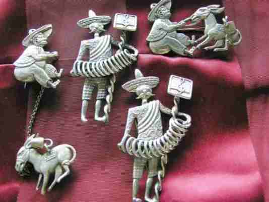 Silver figurine brooches based on a Mexican motif