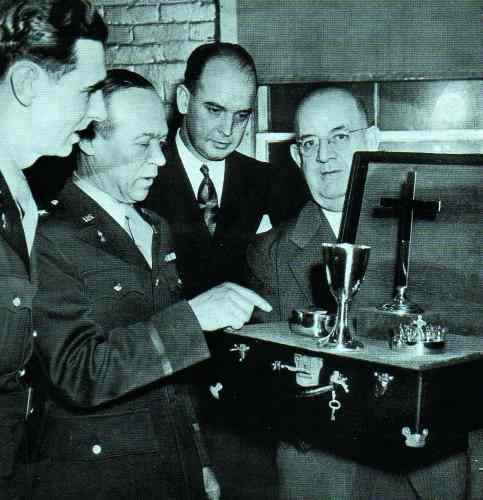 a publicity photo showing a rather fancy chaplains set surrounded by International officers