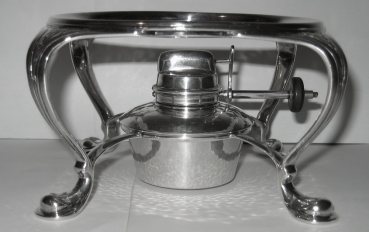 burner on a silver tea kettle manufactured by Liberty & Co