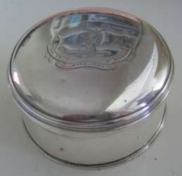 circular silver box with Buxton crest