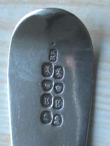 spoon in which the marks have been struck twice by London Assay Office