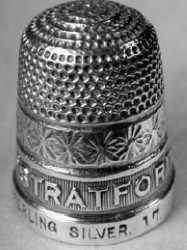thimble with place name stamped or milled into the border