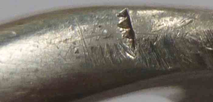 unidentified punch opposite the anvil mark