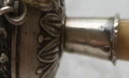 boar head mark on the handle of a silver rattle
