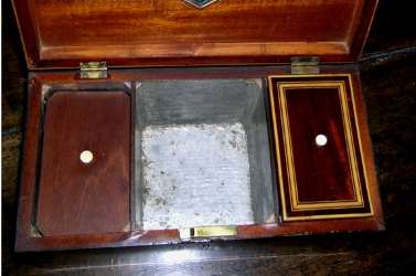 19th century tea caddy showing the central compartment for sugar