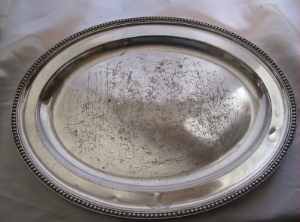 A silver plate dish with the crest of M'Nab family