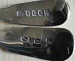 Top marking on sugar sifter spoons showing different fly press stubs used to mark spoons of similar size