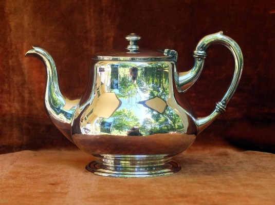 A silver-plated teapot bearing the round mark (1900)