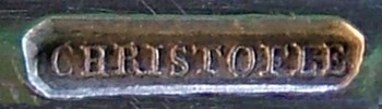 The inscription CHRISTOFLE in a rectangular cartouche with rounded corners