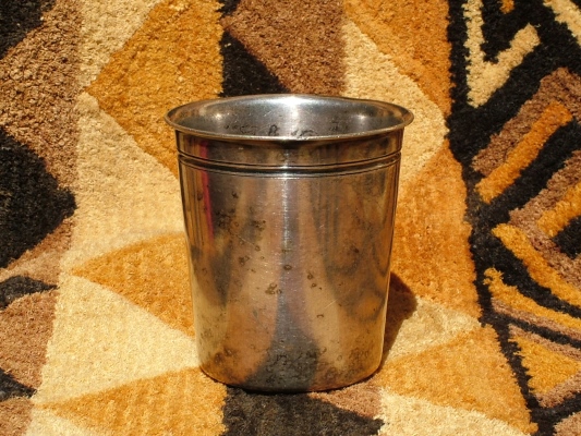 An old silver-plated beaker made from brass before 1890 