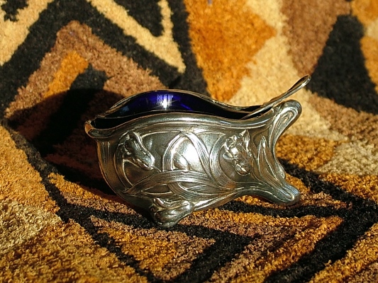 An Art-Nouveau salt cellar with a cobalt-glass inlet and a spoon inside