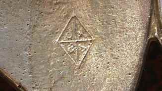 close up of silver hallmarks on brooch backside