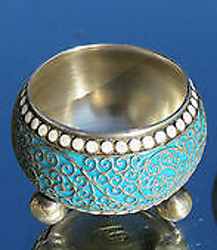 Close up of white cloisonn border and silver beaded wire design