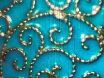 Close up of white cloisonn border and silver beaded wire design