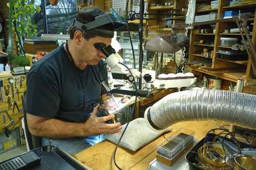 Jeffrey Herman using pulse arc welder on a sterling match safe