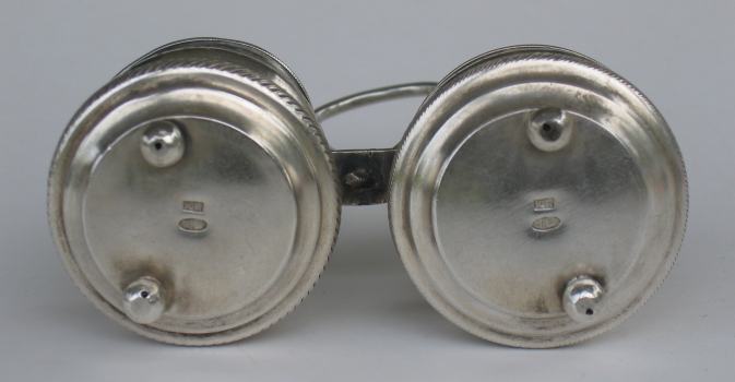 Bottom of double salt cellar, each cellar standing on two ball feet