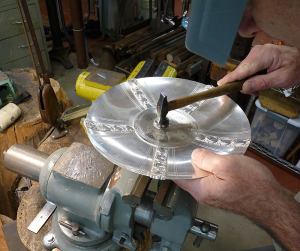 the deposited sterling planished over a slightly domed stake to remove any porosity left by the welding