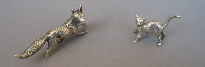 a collection of silver animals