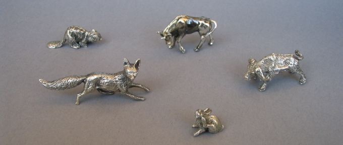 a collection of silver animals