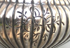 floral engraving on silver vase