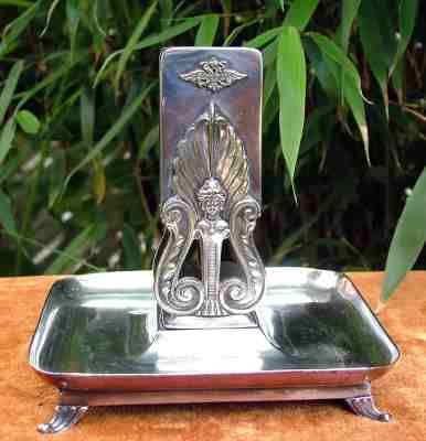 A high-quality silver-plated (Alpacca-Silber I) ash-tray with match holder, issued by
BMF Arthur Krupp between 1891 and 1918 A high-quality silver-plated (Alpacca-Silber I) ash-tray with match holder, issued by
BMF Arthur Krupp between 1891 and 1918